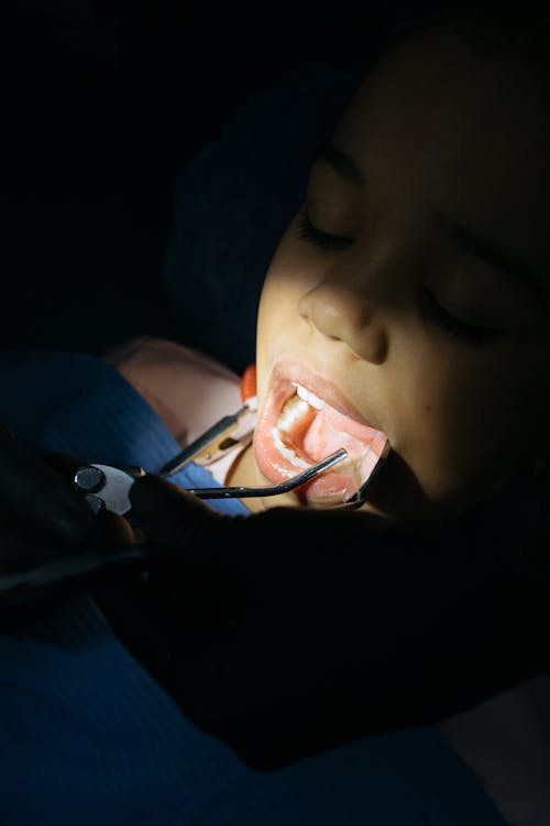 a focus shot of a persons mouth during a dental procedure
